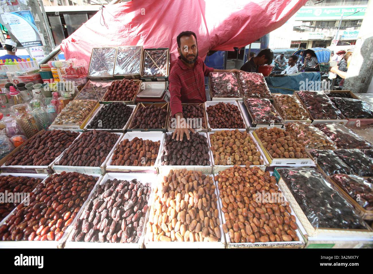 A Bangladeshi shopkeeper is displaying dates for sale, shopkeeper