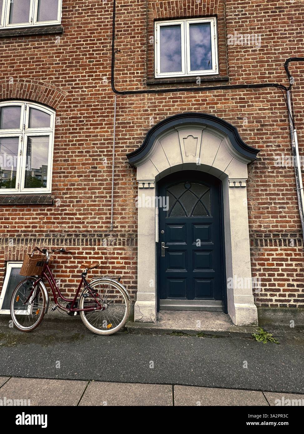 Apartment building front door with bike in Copenhagen, Denmark - Smartphone Captured Stock Image Apartment building front door with bike in Copenhagen, Denmark - Smartphone Captured Stock Image