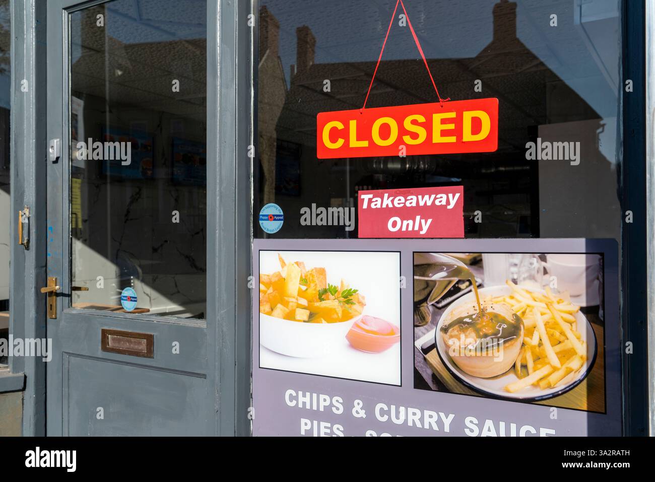 Closed sign in the window of a food takeaway restaurant Stock Photo