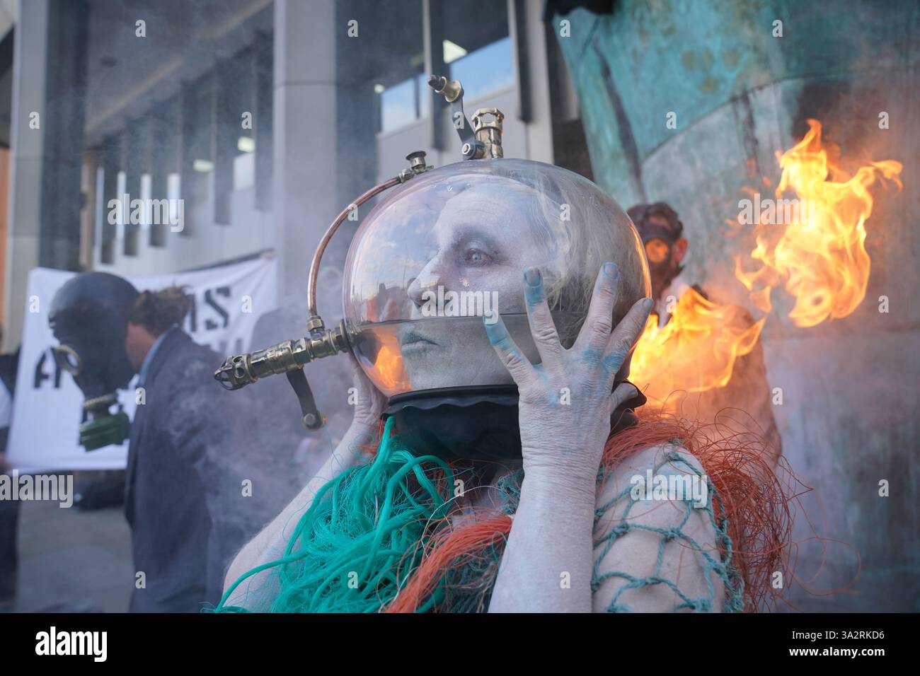 An Ocean Rebellion campaigner, dressed as an oceanic goddess with her ...