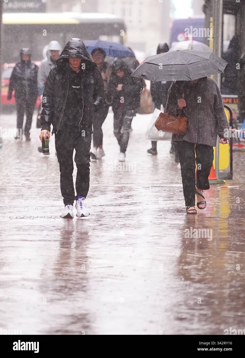 People walking in the rain in Blackpool. Temperatures could hit 20C in ...