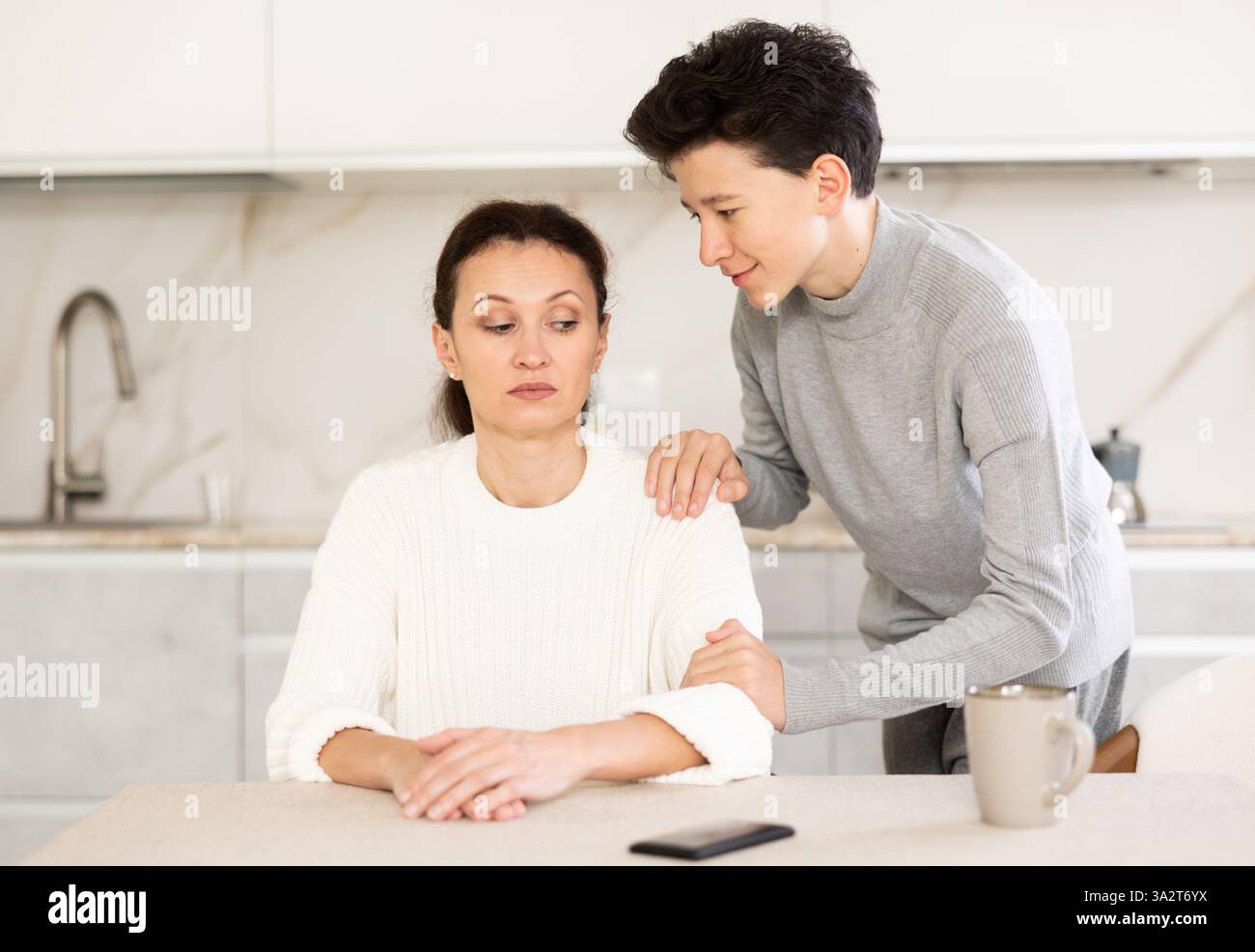 Boy asking mother for forgiveness Stock Photo - Alamy