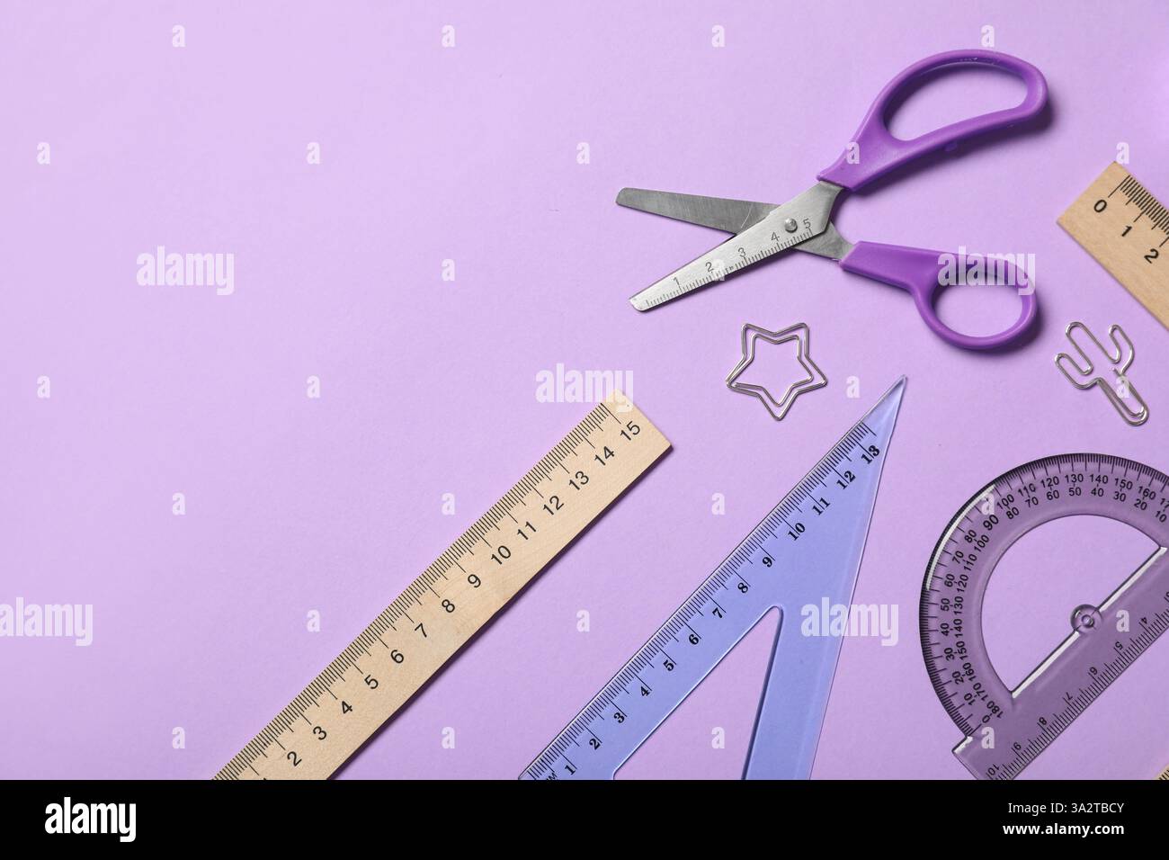 Paper Clip As Ruler Different rulers with scissors and paper clips on purple background ...