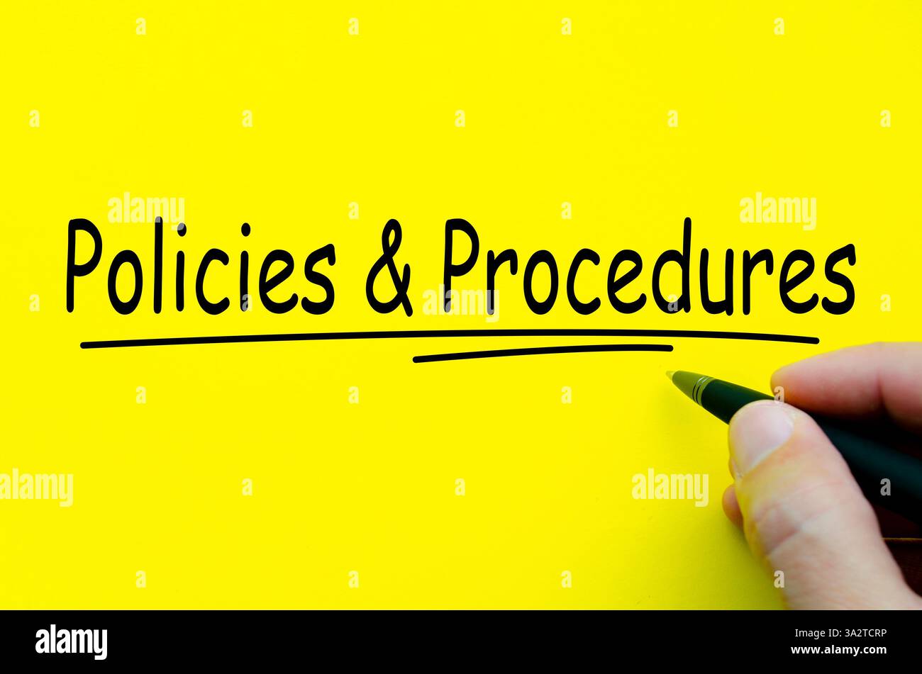 Policies and Procedures hand written text on yellow notepad. Stock Photo