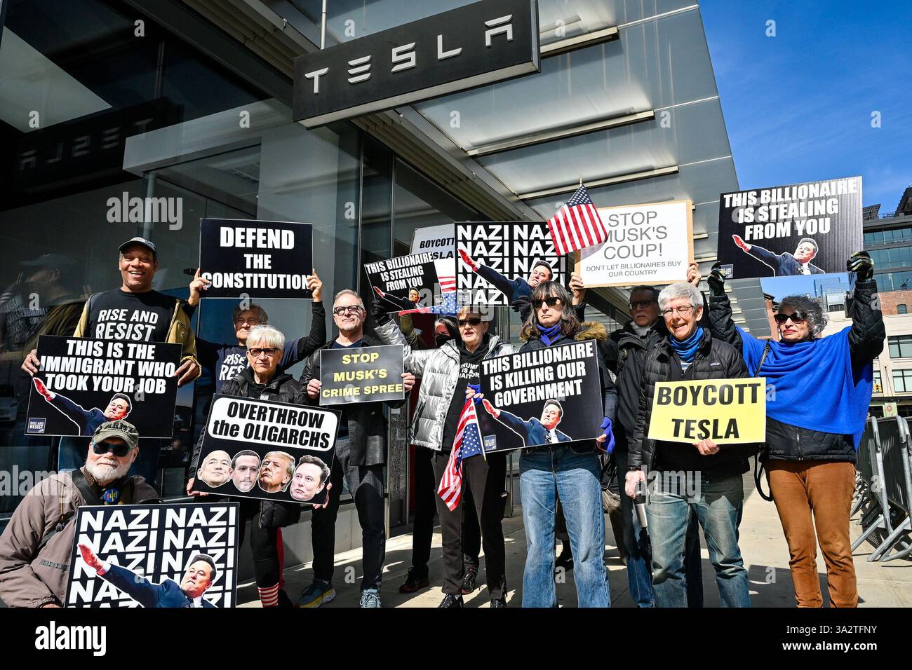 Activists with the nonviolent political action group Rise & Resist protest Elon Musk outside