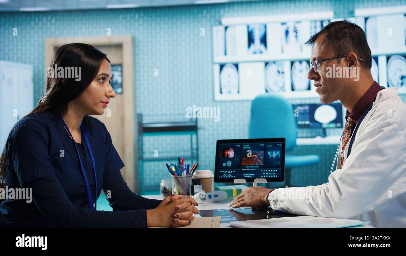 Physician meeting with patient to discuss medical test results in ...