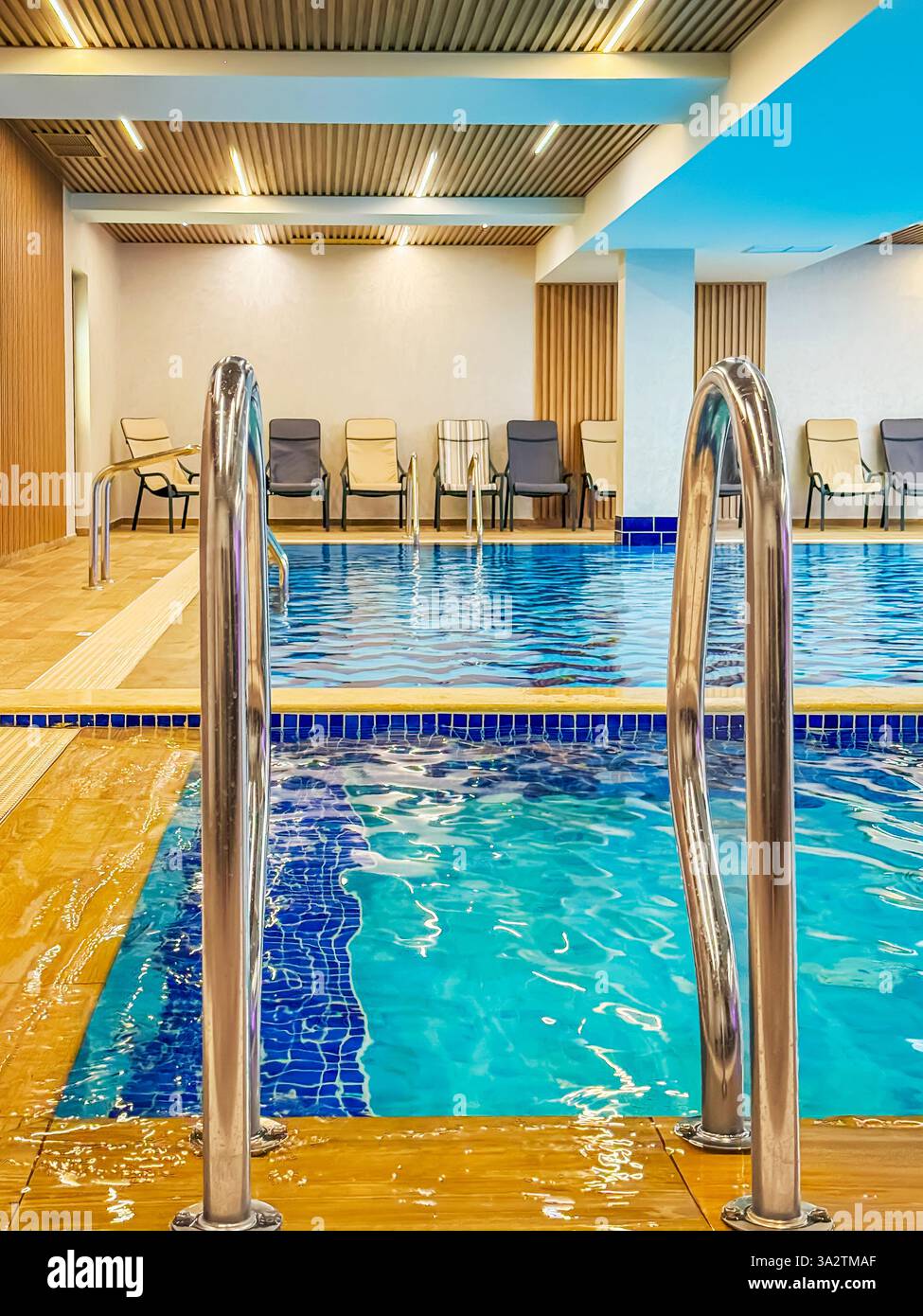 Swimming pool handrails. Indoor swimming pool with stainless steel ...