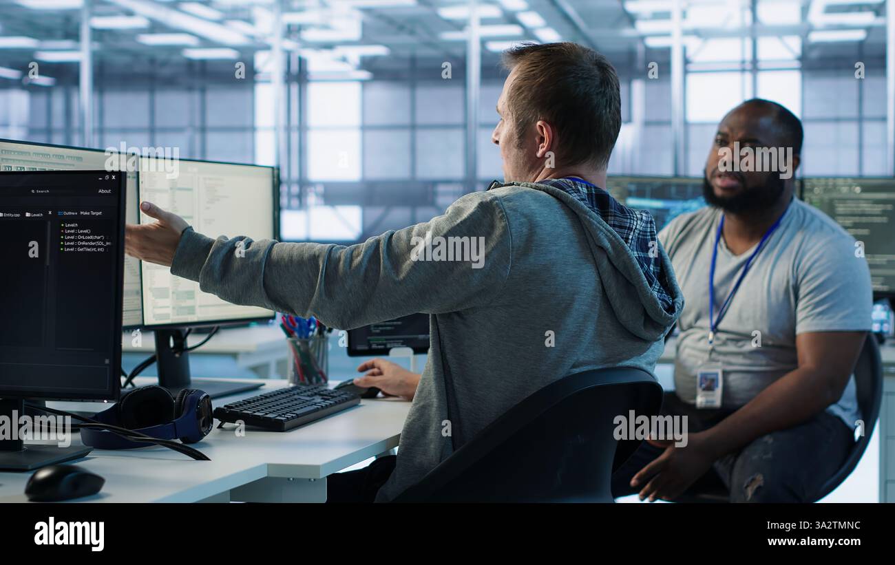Manager admonishing programmer after making error damaging high tech data center. Supervisor scolding IT staff member after doing mistake in server room affecting supercomputers, camera A Stock Photo