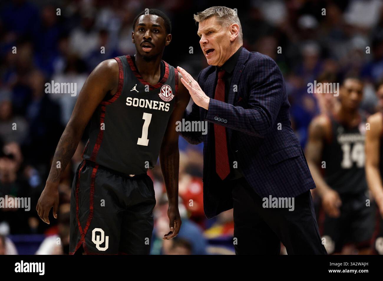 Oklahoma head coach Porter Moser speaks to Kobe Elvis (1) during the ...