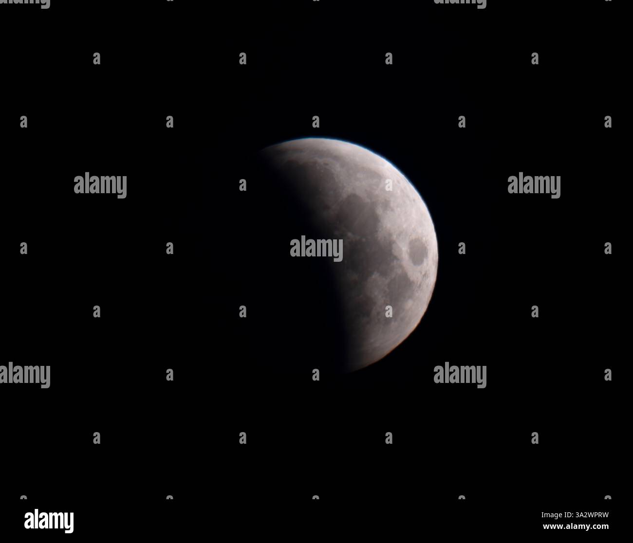 London, UK. 14th Mar, 2025. The partial lunar eclipse in progress ...