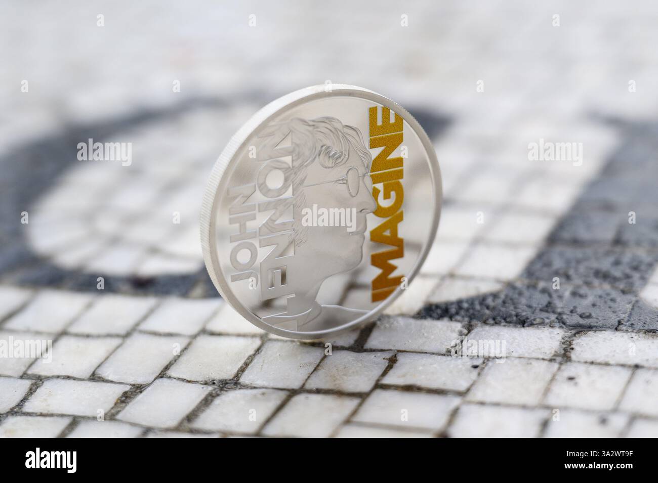 EDITORIAL USE ONLY A collectable coin featuring John Lennon and the ...