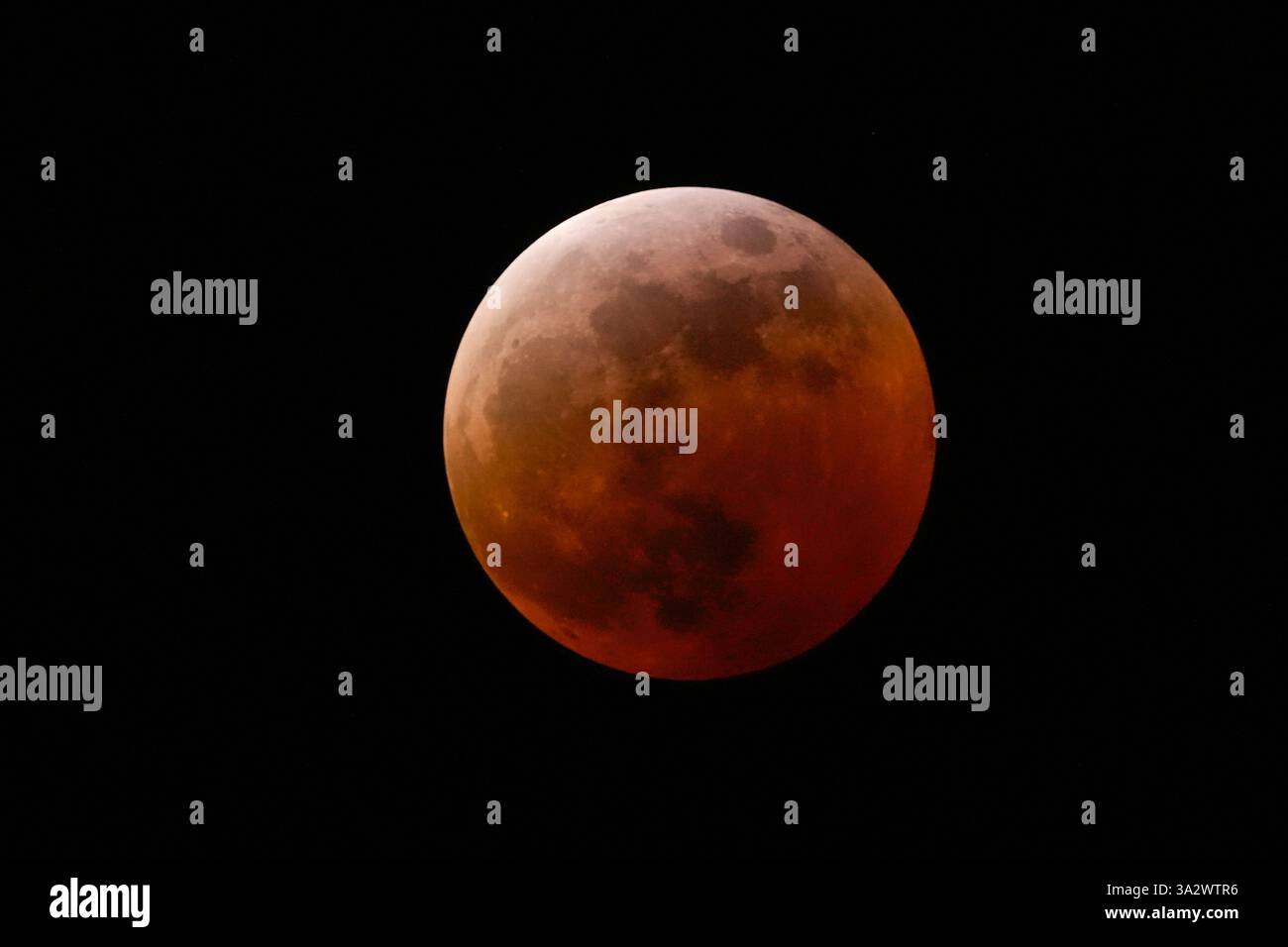 The moon shines over Mexico City during a total lunar eclipse, in Mexico City, Friday, March 14