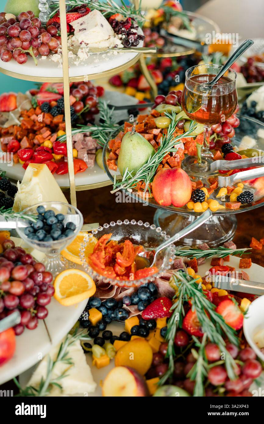 Luxurious charcuterie display with fruits, cheeses, and garnishes. Stock Photo