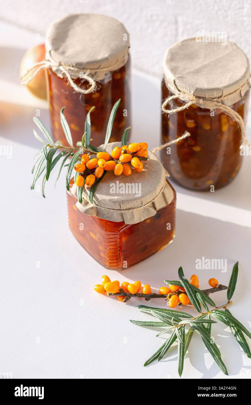 A collection of jars filled with golden seabuckthorn and apple jam Stock Photo