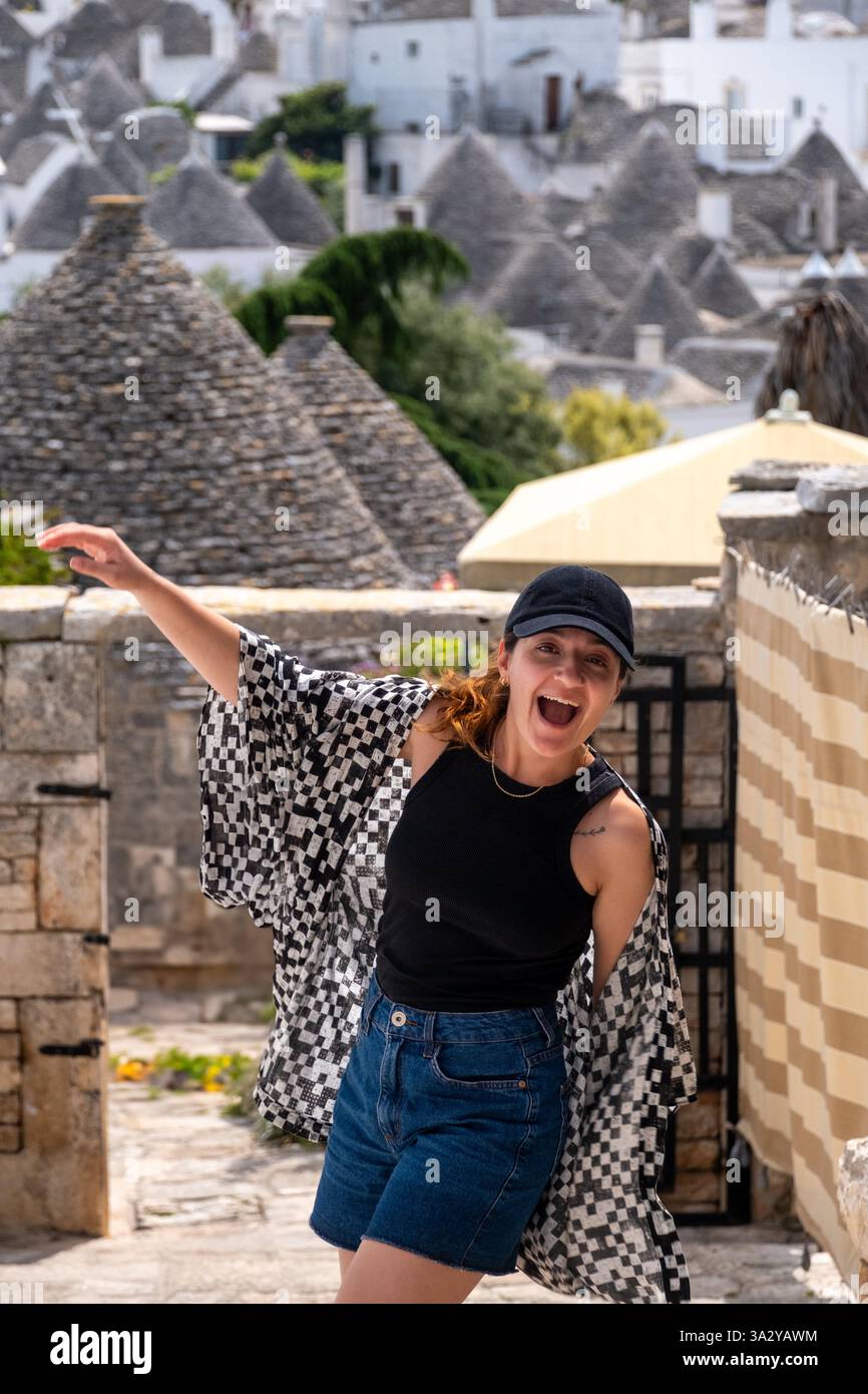 White woman smiling and happy in Alberobello, Italy Stock Photo