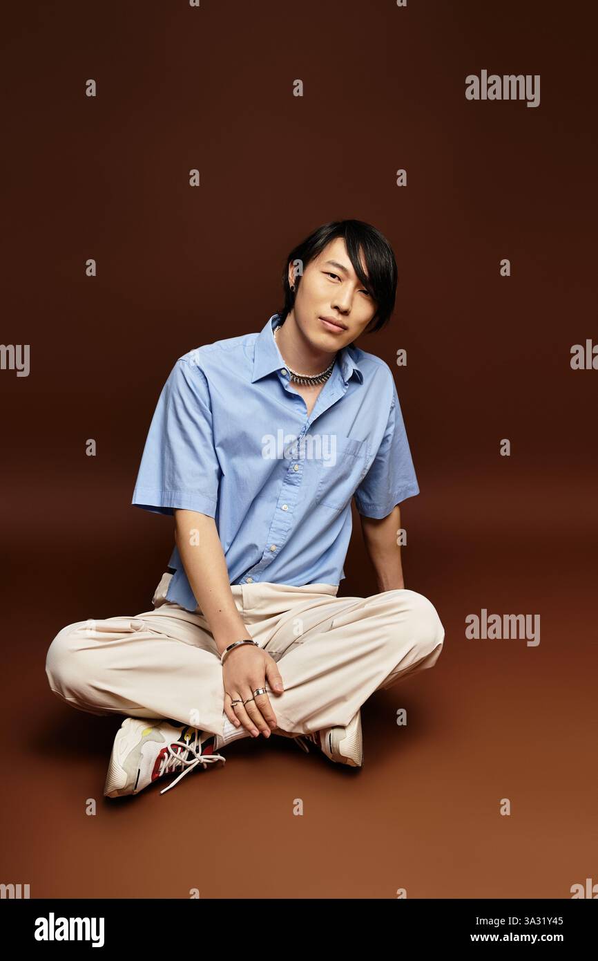 A handsome young man poses confidently in a stylish outfit surrounded ...