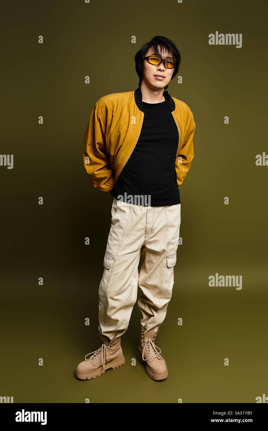 Stylish young man poses confidently in a modern studio setting, exuding ...