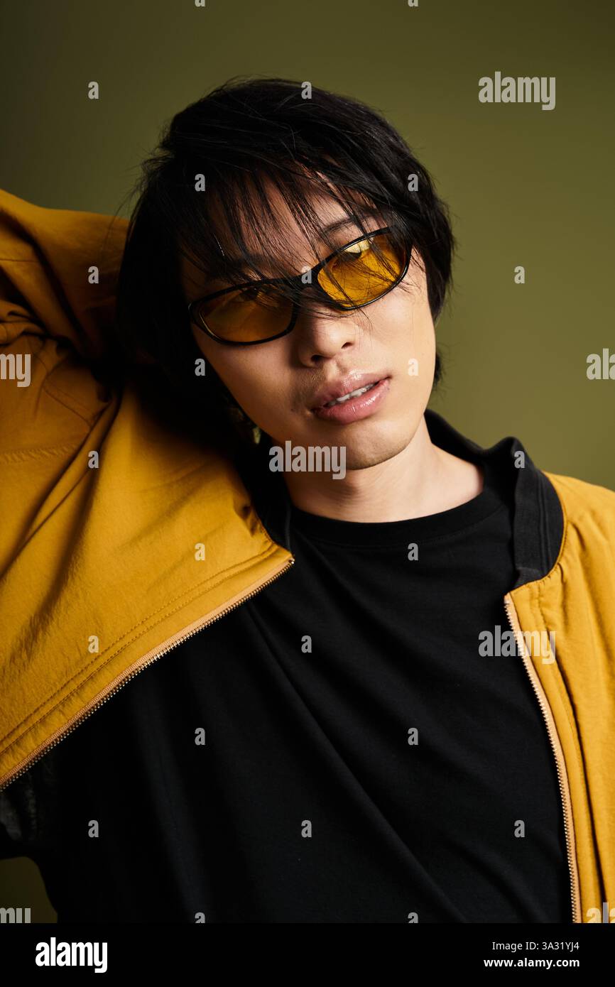 Young man poses confidently in a stylish outfit with vibrant colors in ...