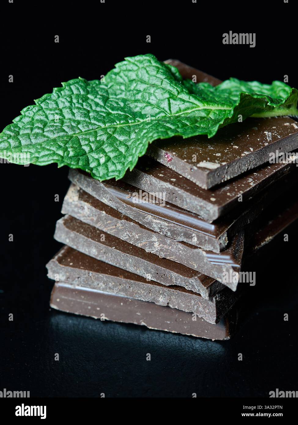 Chocolate and nut bars with a mint leaf Stock Photo
