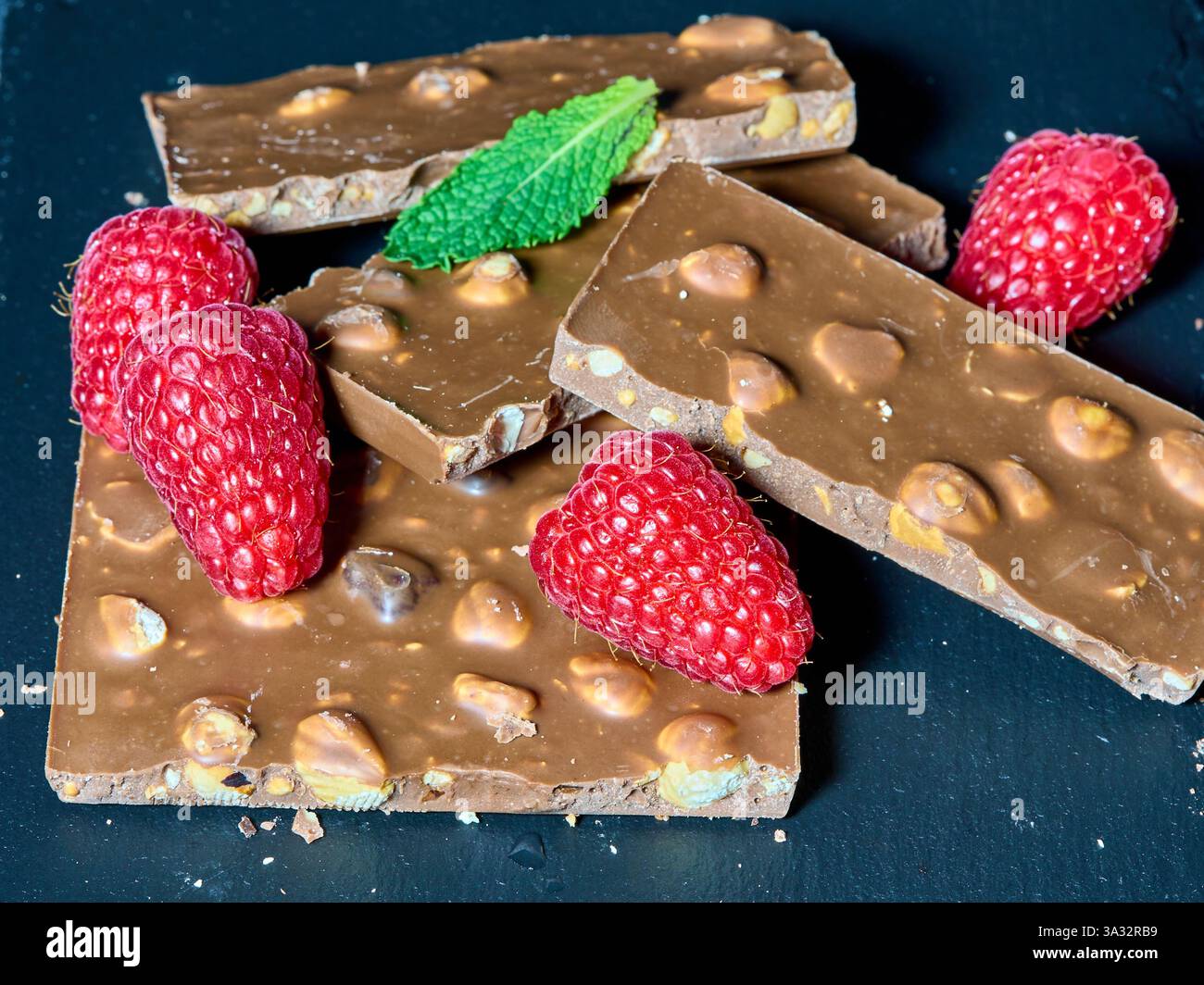 Chocolate and raspberries with a mint leaf Stock Photo - Alamy