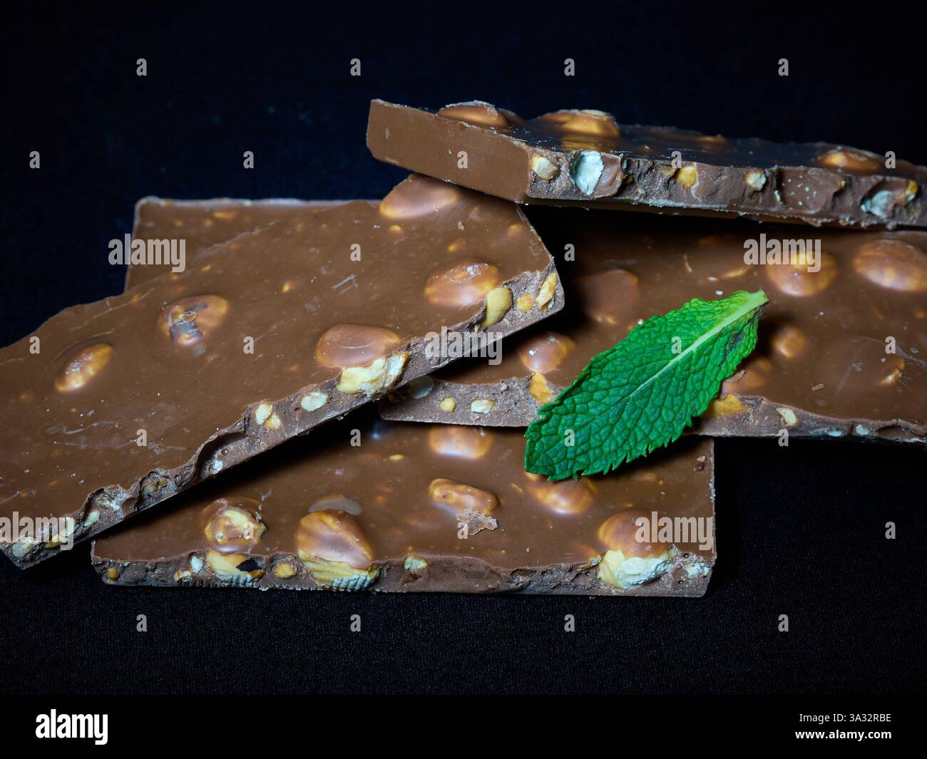 Chocolate and nut bars with a mint leaf Stock Photo