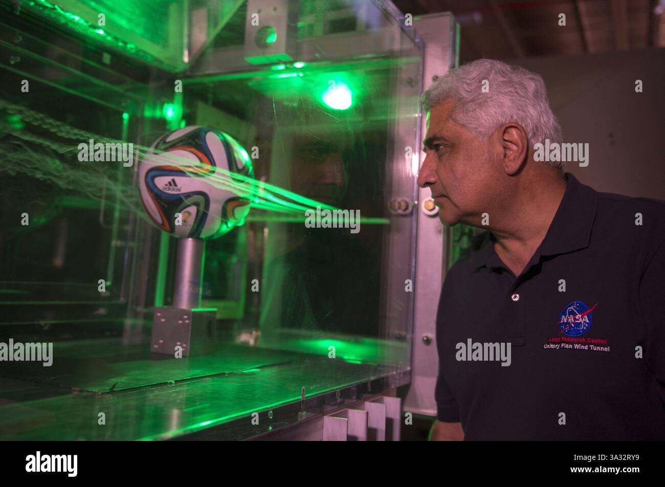 Jun 12, 2014 - Dr. Rabi Mehta uses smoke and lasers to inspect the flow pattern around an Adidas Brazuca football..NASA tests aerodynamics of FIFA 2014 World Cup ball, Mountain View, California, America - 12 June 2014..It might have no bearing on the talents of football players like Neymar and Messi, but NASA boffins have been testing the aerodynamics of this year's World Cup ball design, developed by Adidas and dubbed the Brazuca ball.....Although NASA is not in the business of designing or testing balls, the tournament provides an opportunity to explain the concepts of aerodynamics to studen Stock Photo