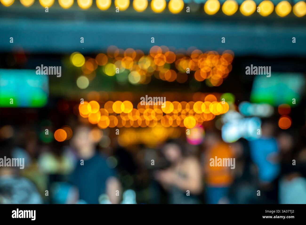 blurred scene of a night market, by food vendors, local artists, and live entertainment in an open-air setting Stock Photo
