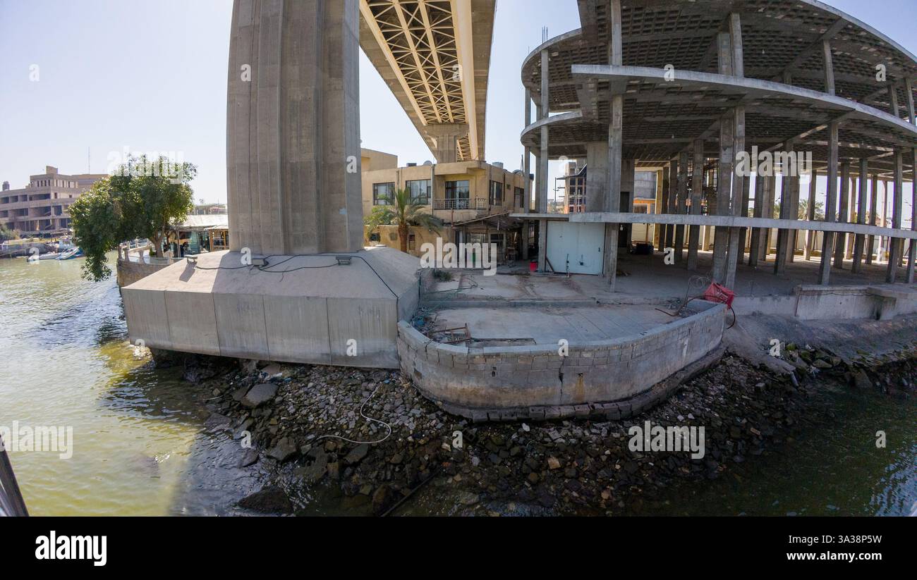 Bridge Structure Incomplete A partially constructed building next to a river, with a bridge ...