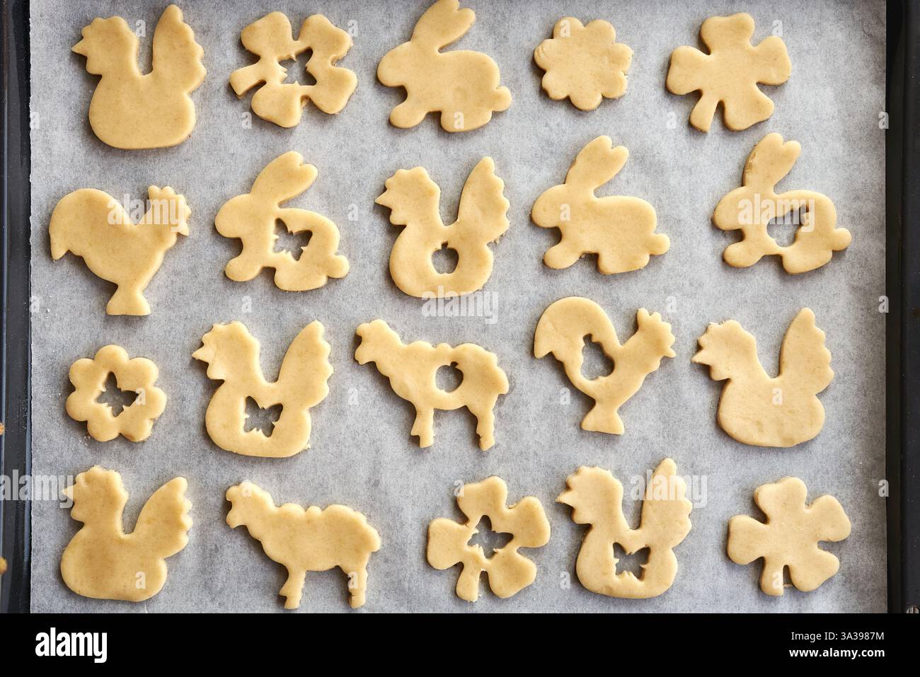 Animal shaped Linzer Easter cookies on a baking sheet, top view Stock Photo