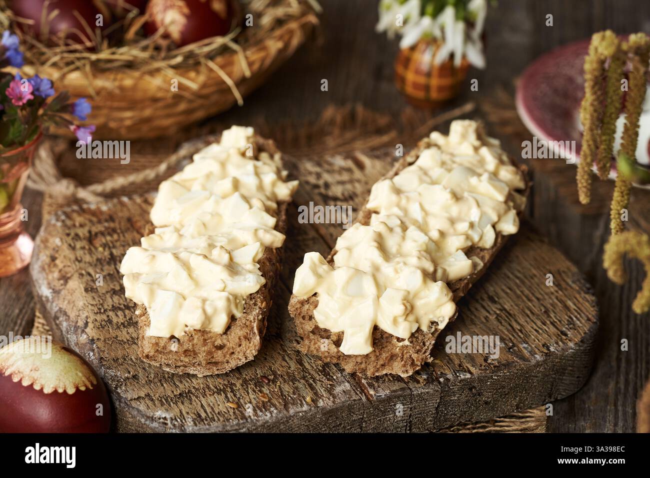 Two slices of bread with spread made of leftover Easter eggs in spring Stock Photo