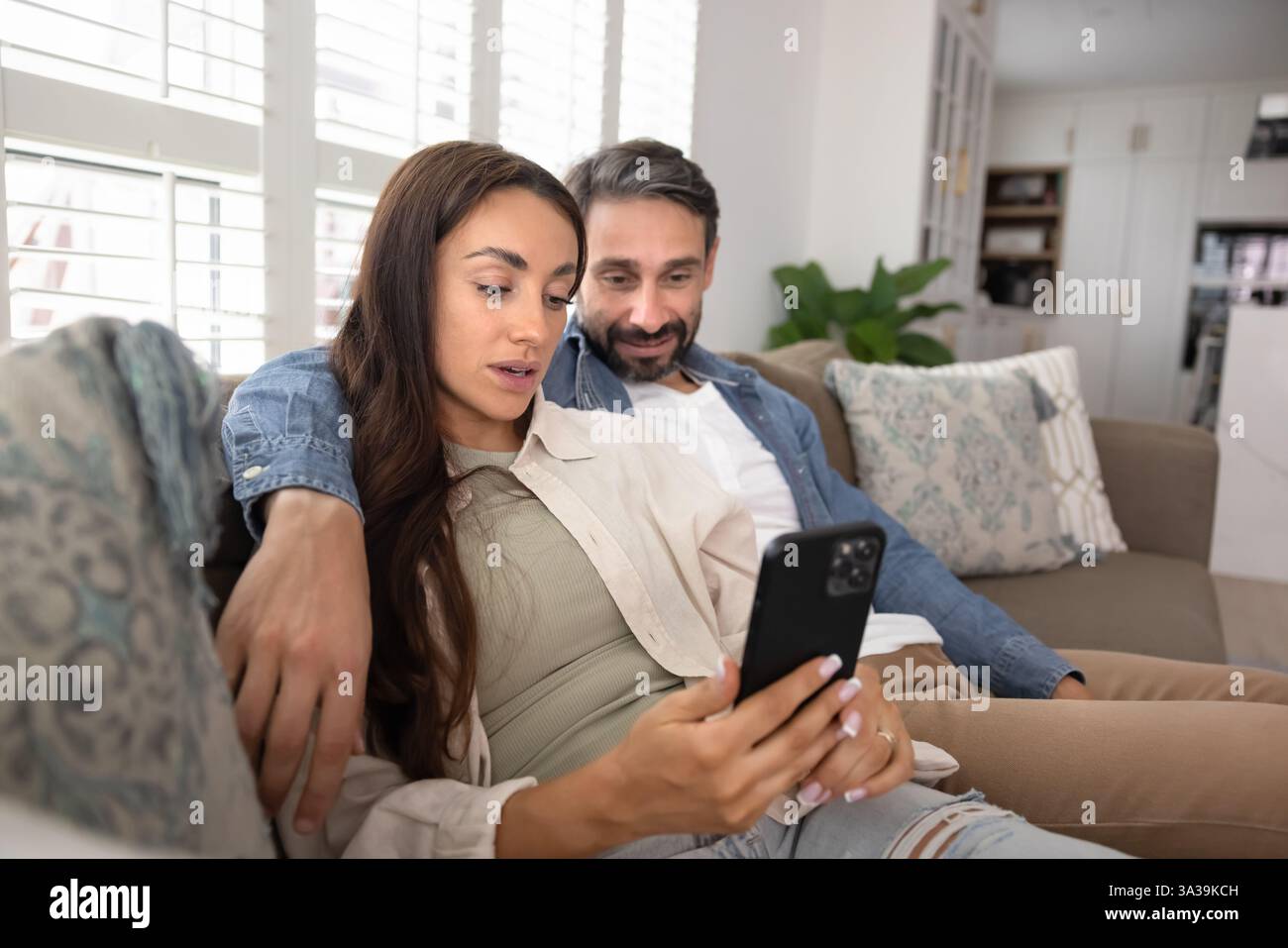 Couple using web service, app on smartphone for Internet communication Stock Photo