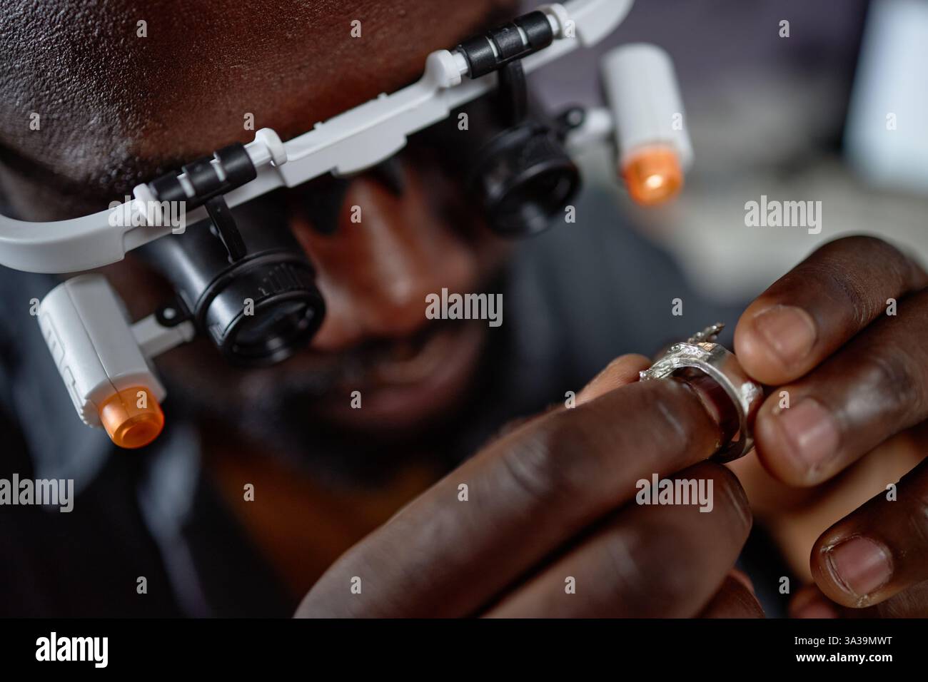 Serious elder engineer in work helmet using digital tablet to control the work on factory Stock Photo