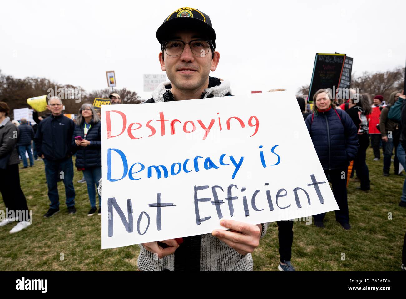 Person with a sign saying