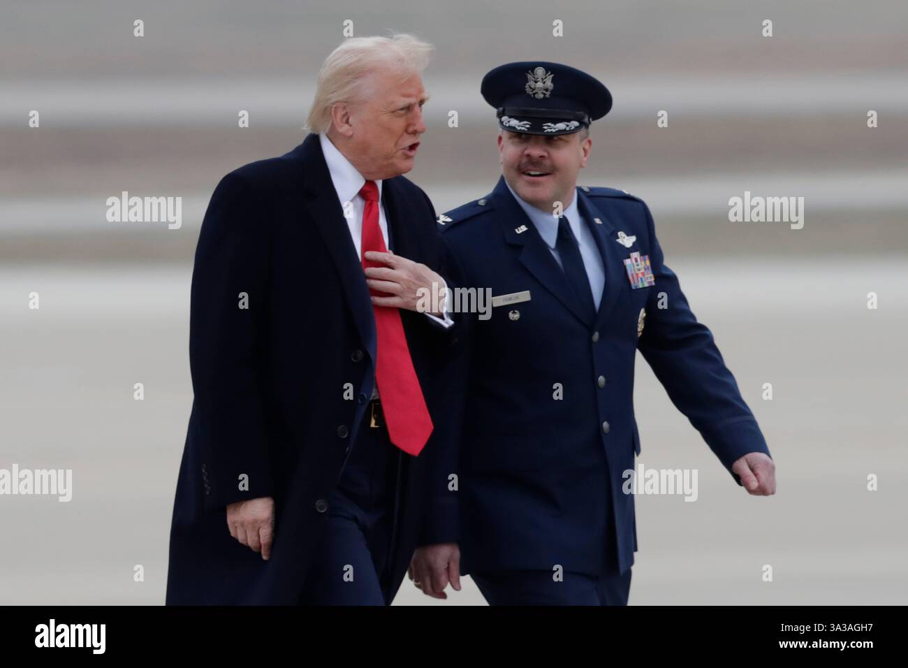 President Donald Trump speaks with Col. Paul Pawluk, Vice Commander of the 89th Airlift Wing, as