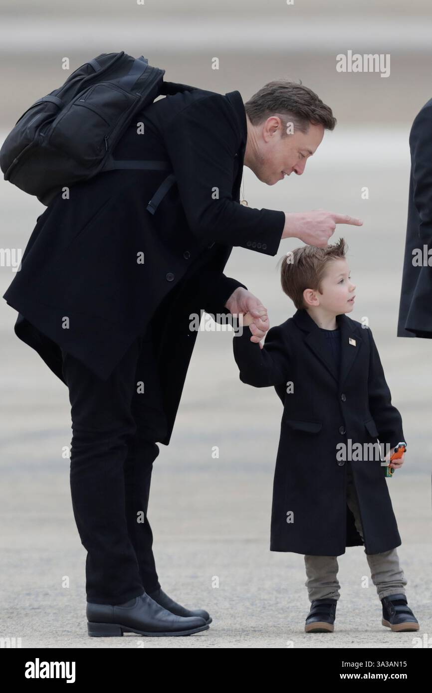 Elon Musk, left and his son X Æ AXii, right, wait as President Donald Trump speaks with the