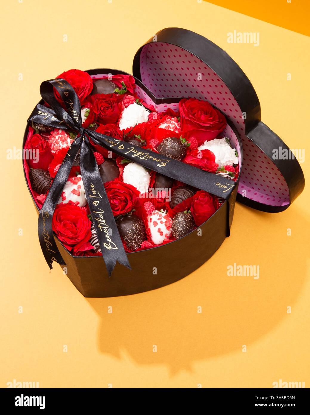 Top-down view of a heart-shaped box filled with roses, chocolate ...