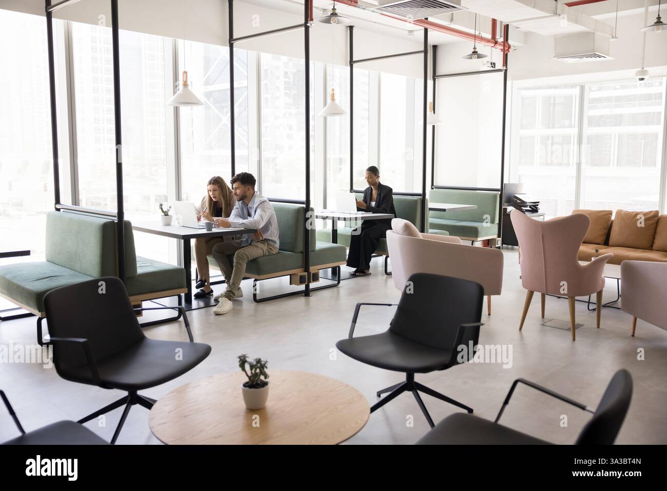 People working in modern, open-space co-working area Stock Photo