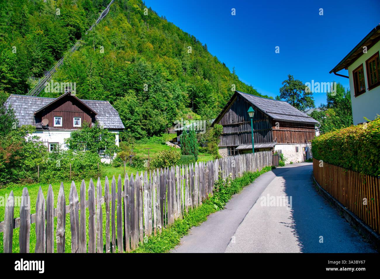 Picturesque view of Hallstatt city and lake, surrounded by stunning alpine mountains and serene waters. Stock Photo