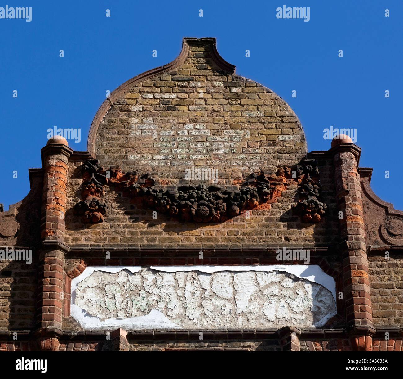 Old Victorian shop front  with space for sign against blue sky for use as a background Stock Photo