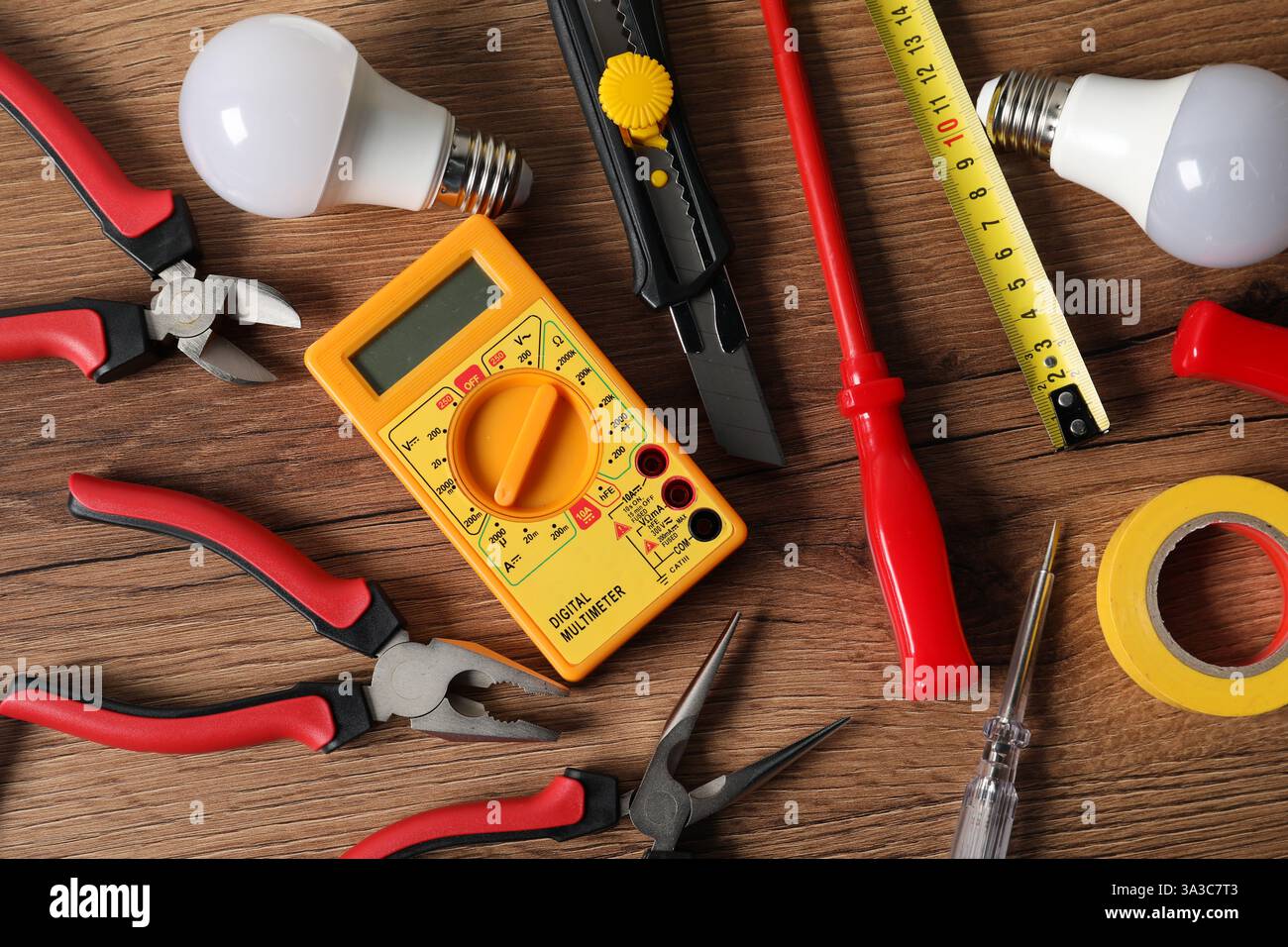 Different electrical tools on wooden table, flat lay Stock Photo