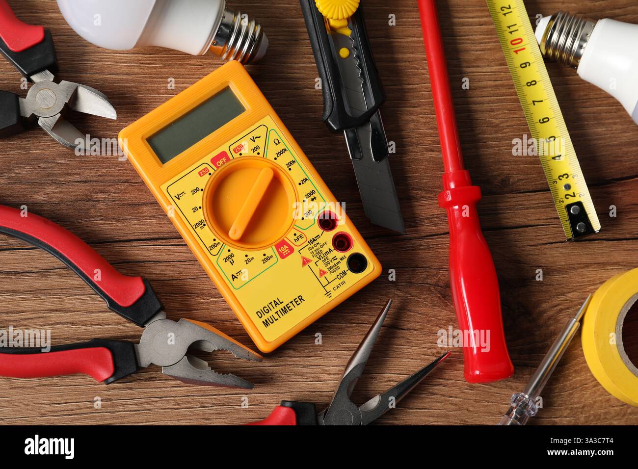 Different electrical tools on wooden table, flat lay Stock Photo