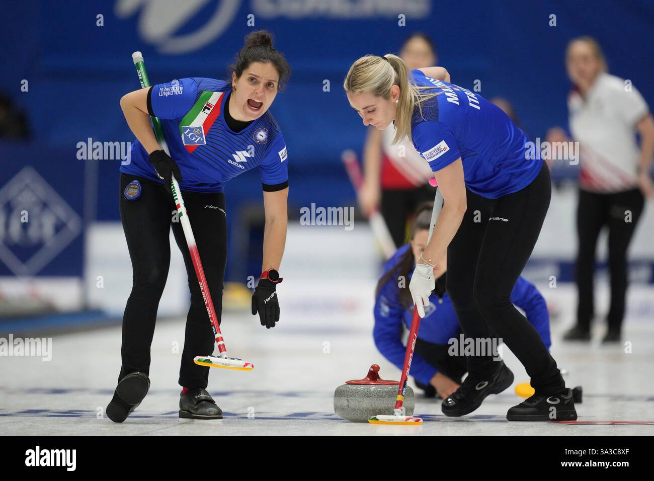 Italy's Angela Romei, left, shouts and Italy's Elena Mathis, sweeps the ...