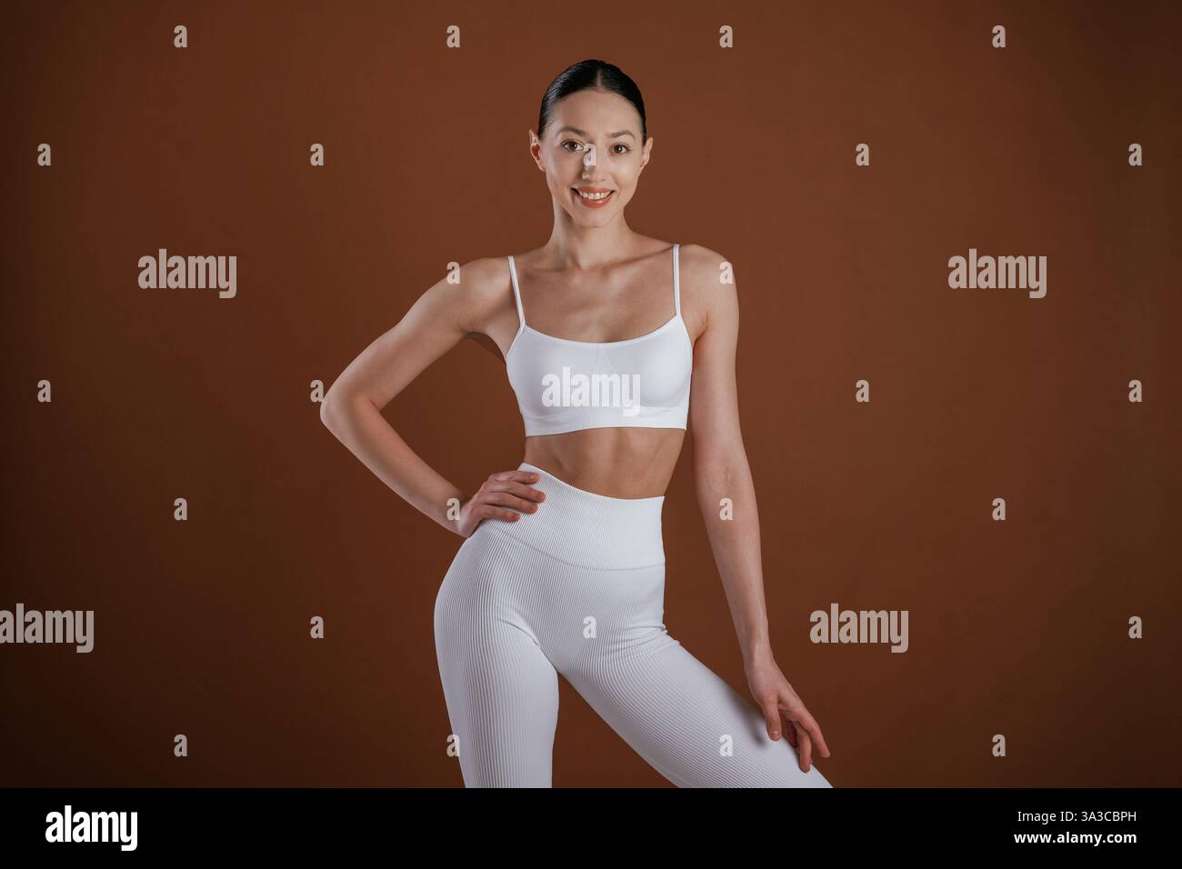 Front view. Beautiful fitness woman is in the studio. Stock Photo