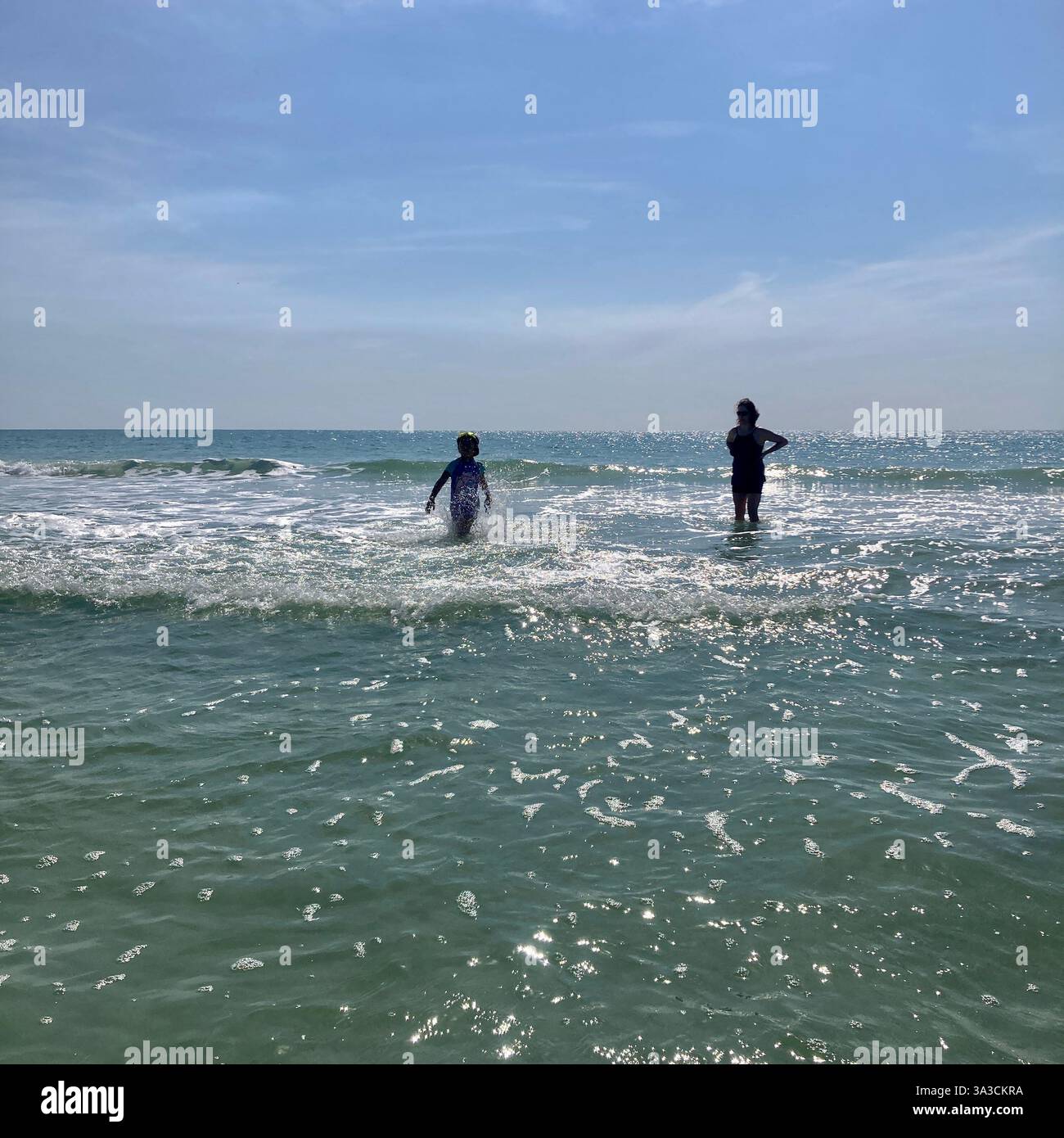 People frolic in the ocean in Florida, USA - Smartphone Captured Stock Image