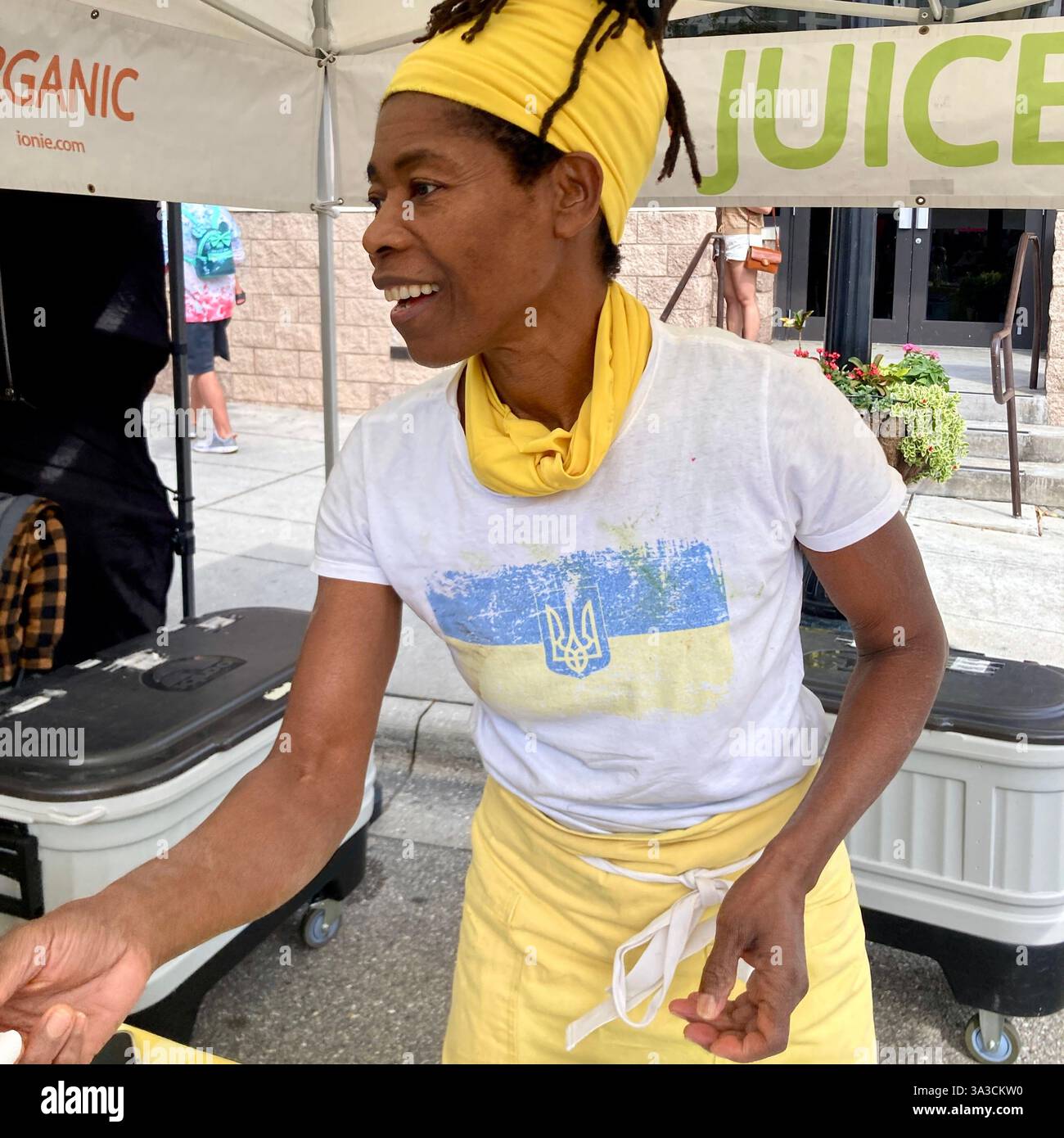 A woman sells freshly squeezed juice at a street market in Sarasota, Florida, USA - Smartphone Captured Stock Image