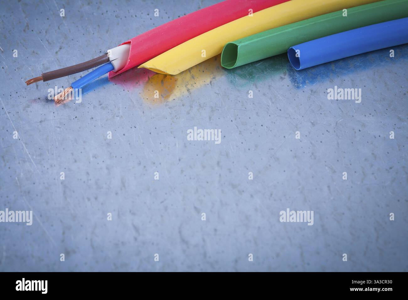 Wire protection and copper cables on scratched metallic background ...