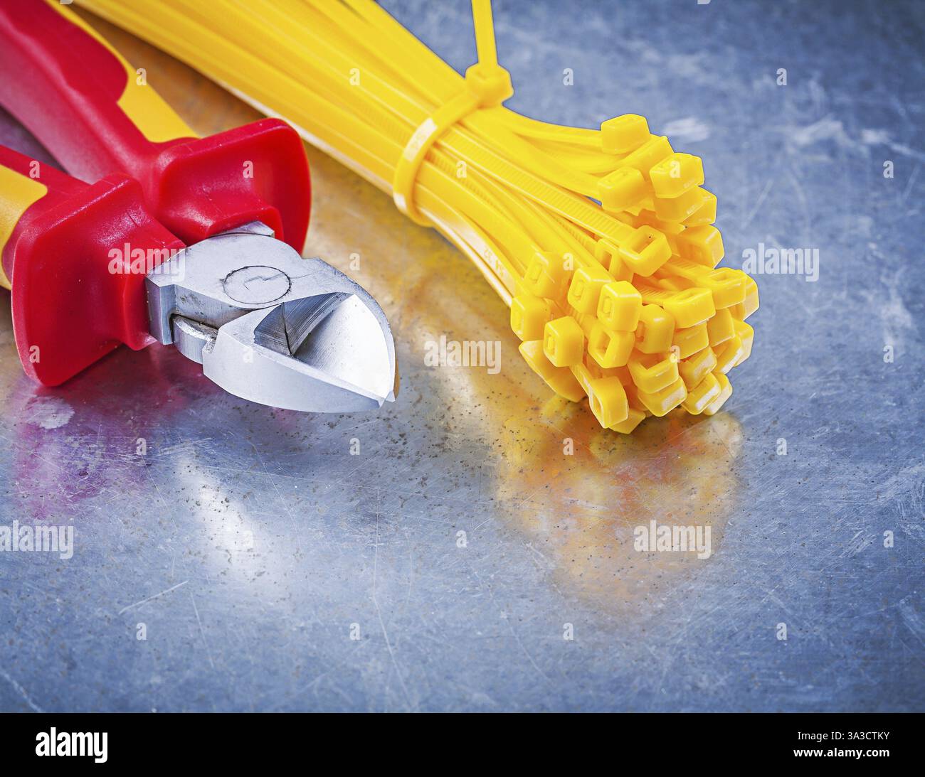 Wire-cutter plastic cable ties on metallic background construction concept Stock Photo
