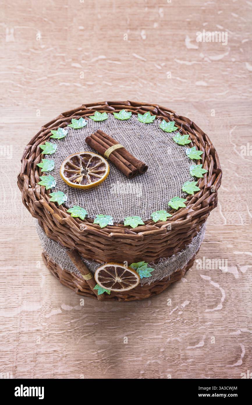 Wicker basket without handle on old wooden board Stock Photo