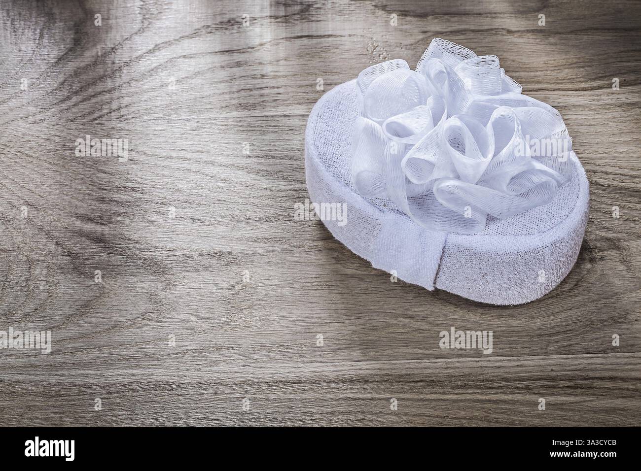 White bath sponge on wooden board bathing items concept Stock Photo