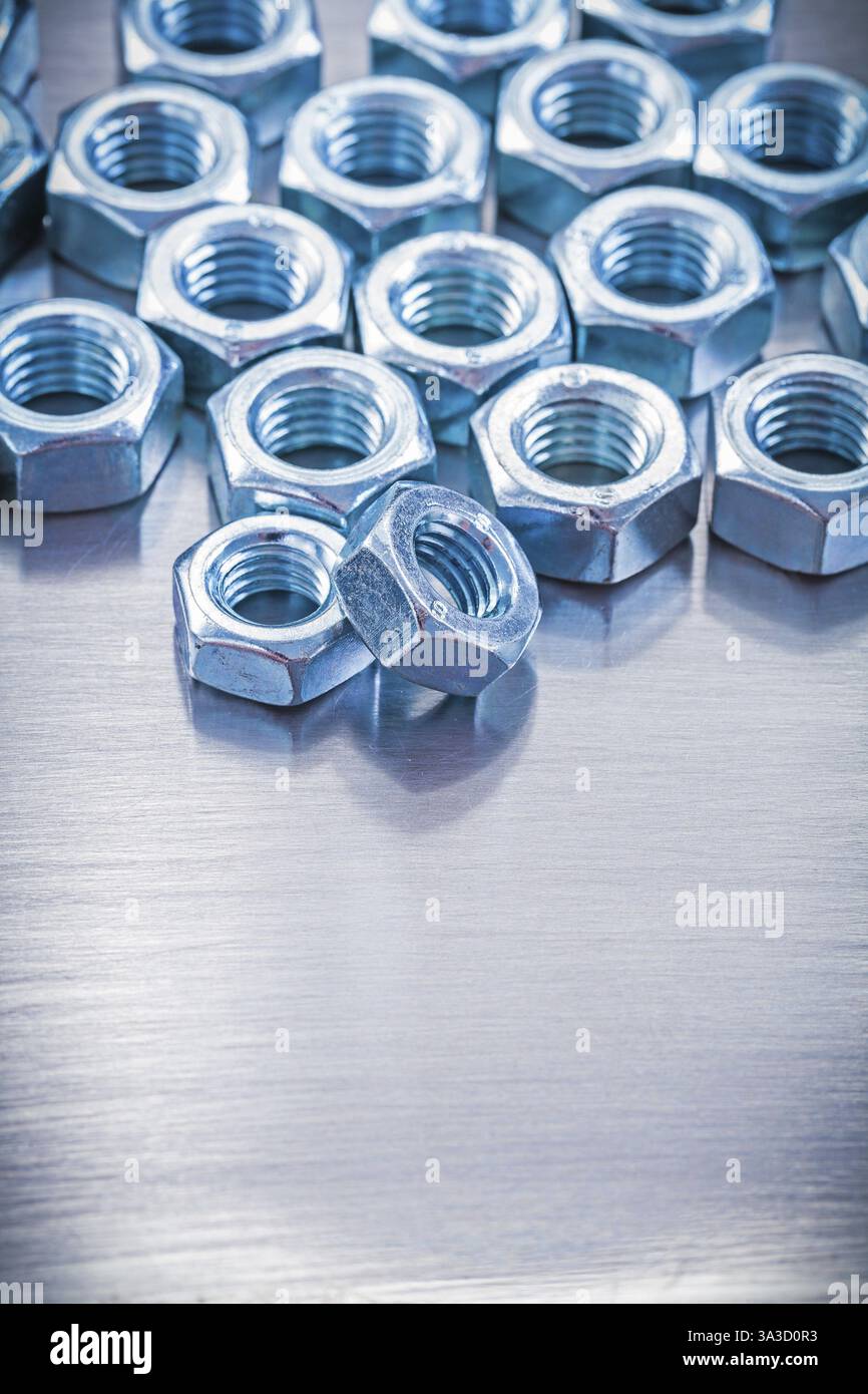 Stack of screw nuts on metallic background construction concept Stock ...